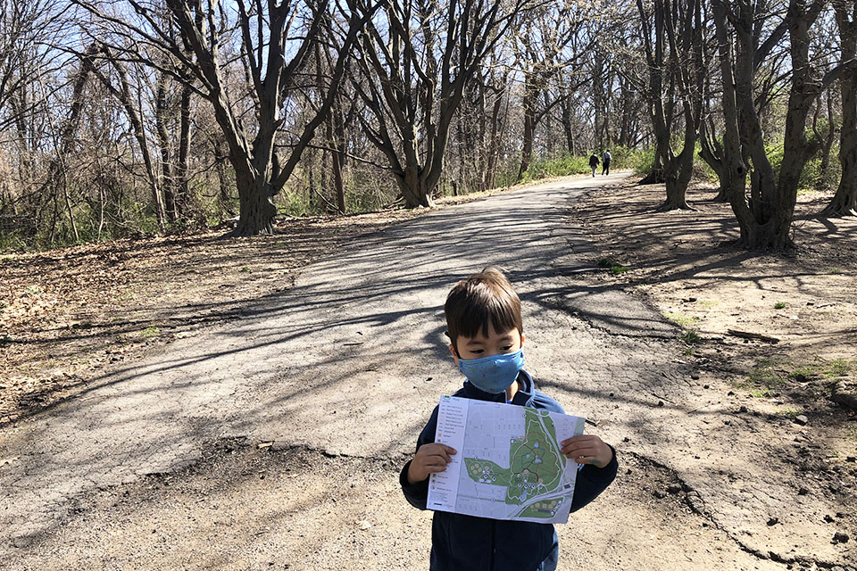 Boy on a park trial with map
