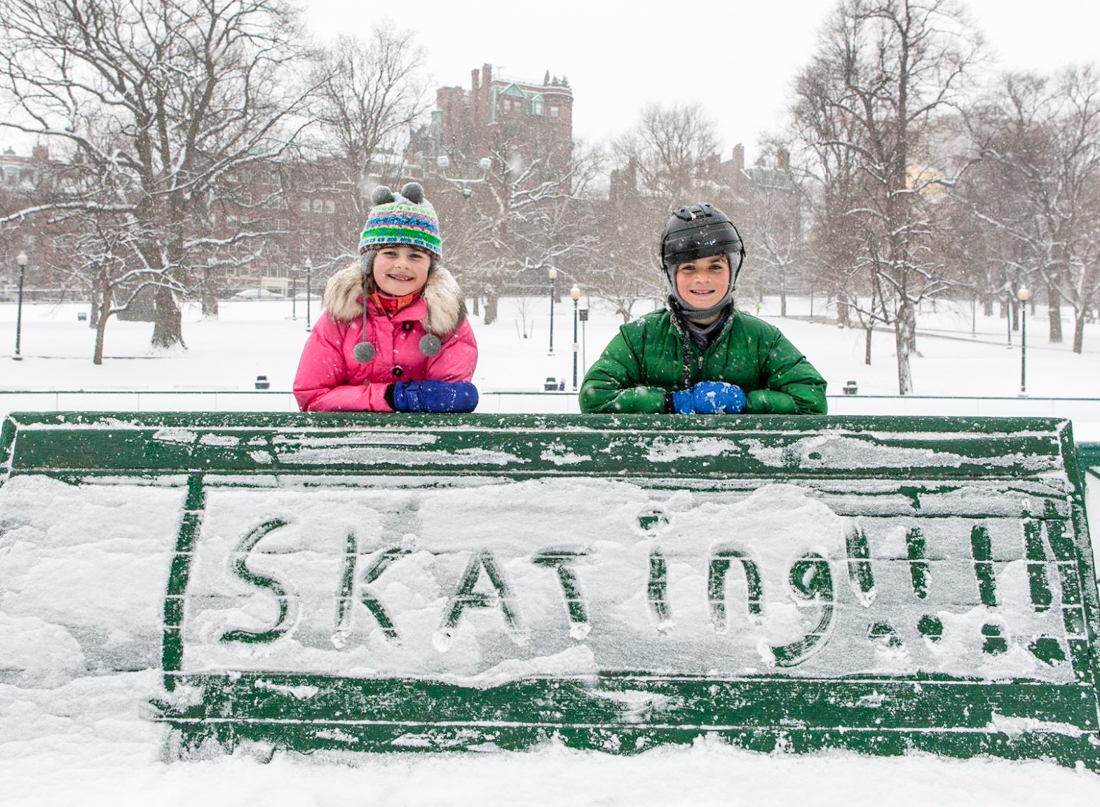 Image of children outdoors in Boston with a hand-written skating sign