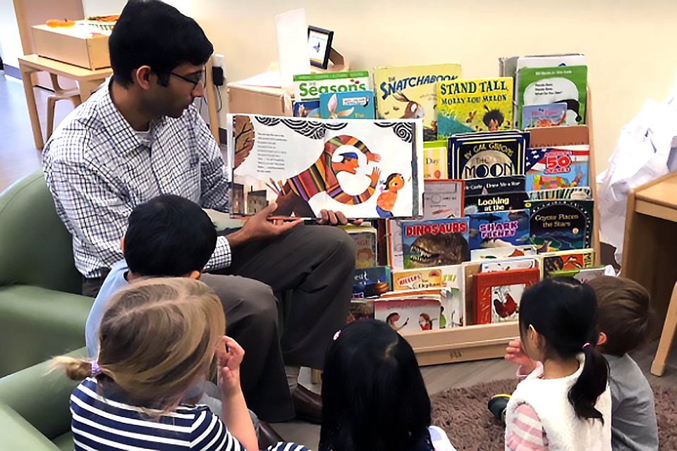 Children gather around for story time at Bright Horizons. 