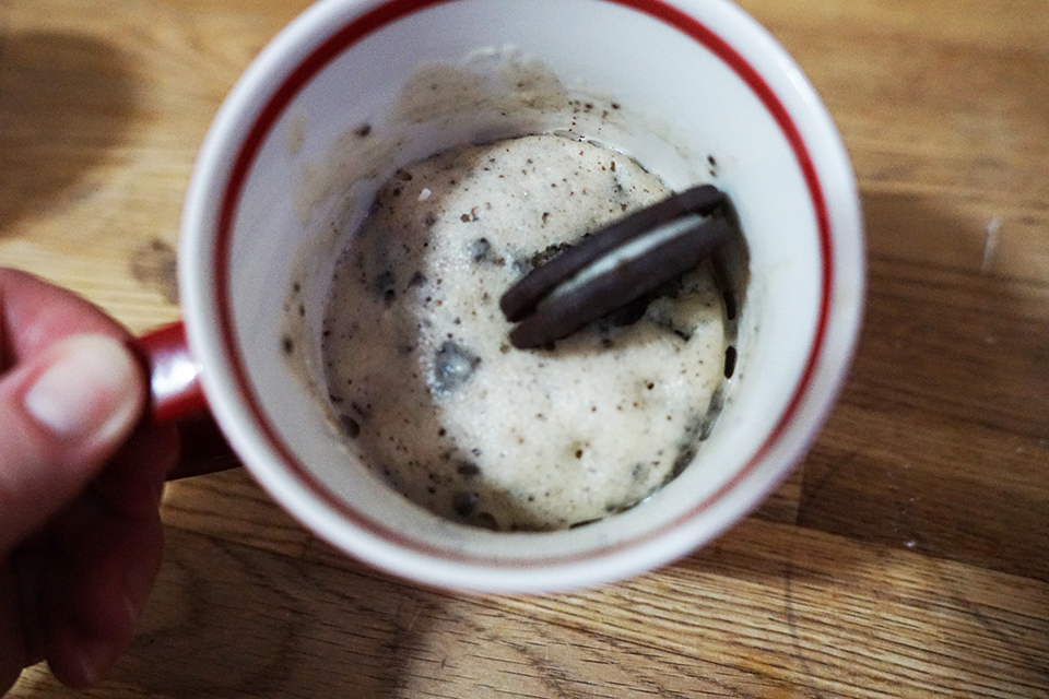 Cookies and Cream Mug Cake topped with an Oreo