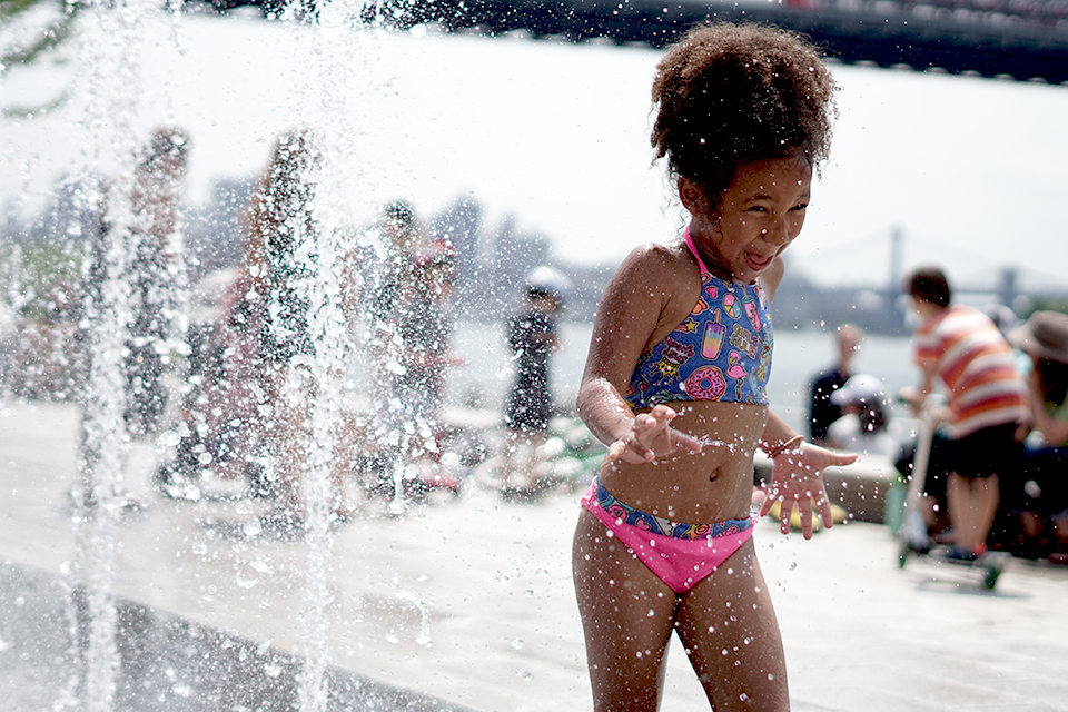 The splash pad in Domino Park puts a smile on faces young and old. Photo by Jody Mercier