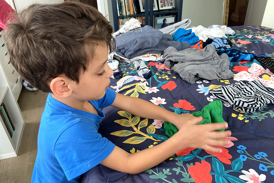 Sensory Activities for Toddlers, Infants, and Kids: Folding launrdy is a great sensory activity that gets your chores done!