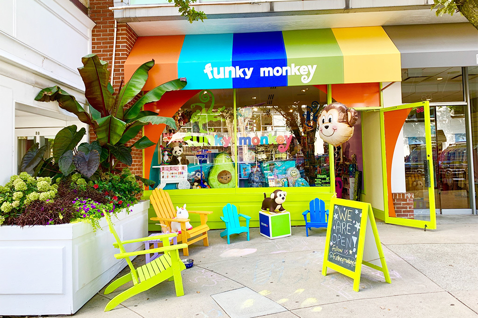 Funky Monkey meets customers outside its bright storefront for contactless curbside order pickup. Photo courtesy of Funky Monkey Toys & Books