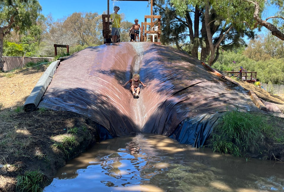 Slide into muddy fun at Adventure Playground! 