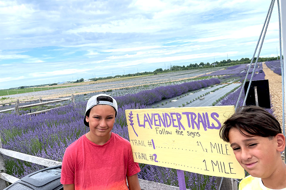 kids pose in front of the lavender trails sign
