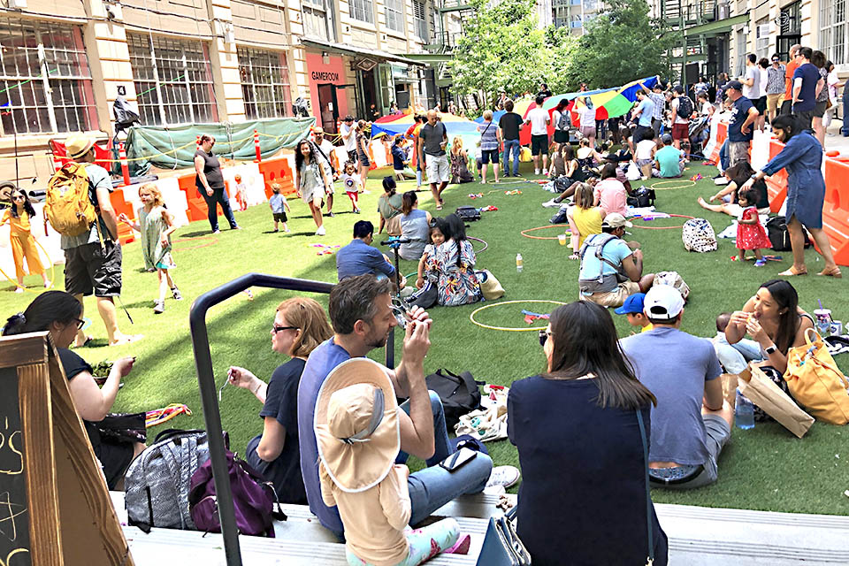 People eating outside of Industry City's food hall in Brooklyn, New York