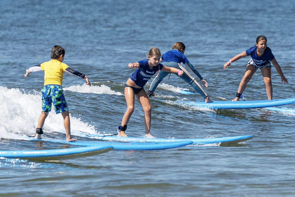 Learn to ride the waves with Skudin Surf in Long Beach. Photo by Jay Belsky