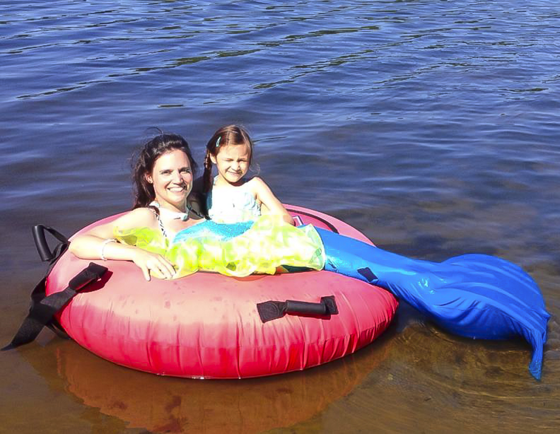 Image of mother and daughter floating in water at a Connecticut beach club.
