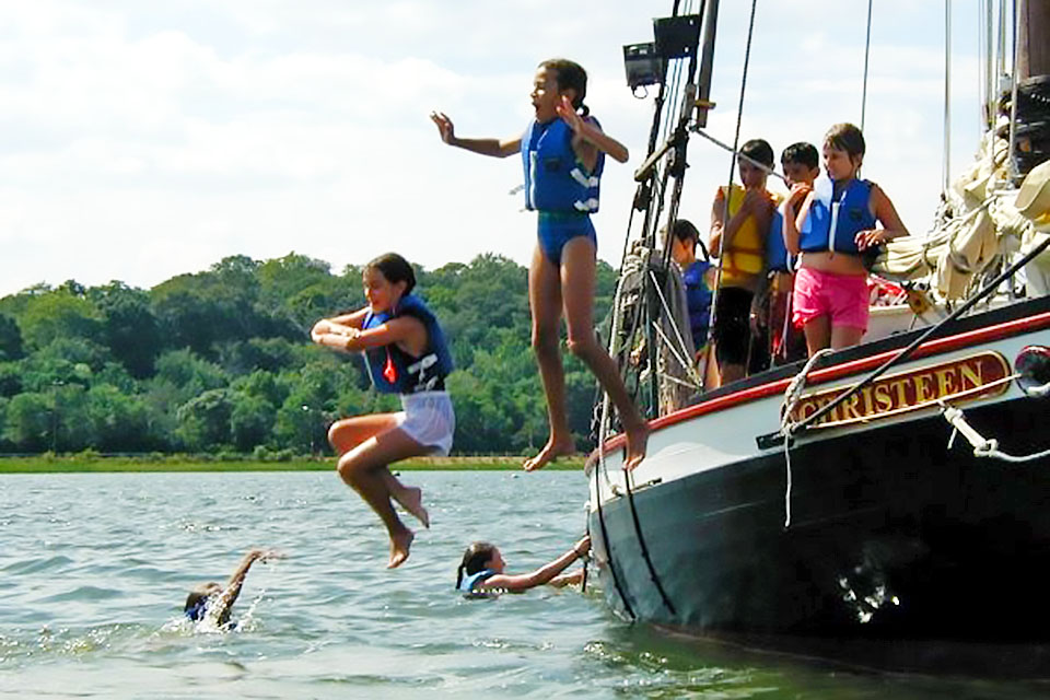 Take the wheel aboard the former oyster sloop Christeen in Oyster Bay.  Photo courtesy of  The WaterFront Center