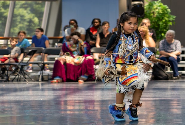Photo of young woman engaging in tribal dance at Foxwoods Resort