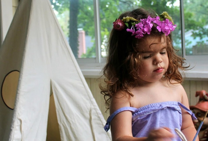 Little girl in a pink flower crown plays: More Holidays & Activities for June 2025 Make a Summer Flower Crown