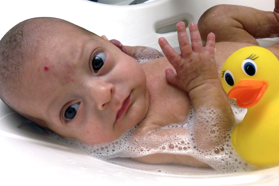 young baby in a baby bath