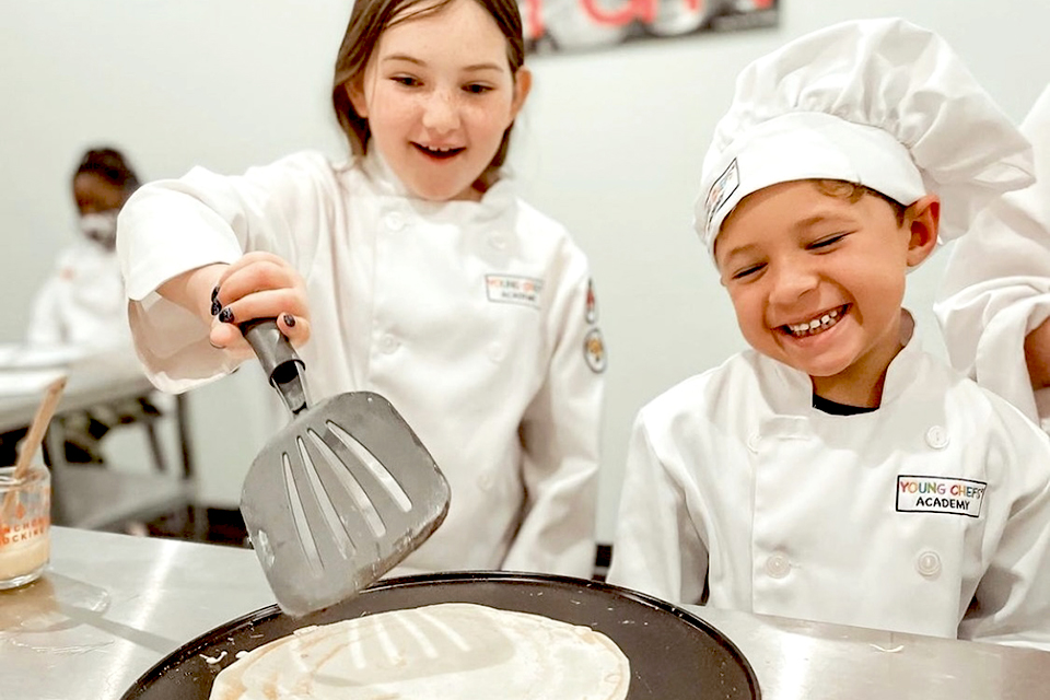 At Young Chefs Academy, kids are guided through a stage-by-stage cooking class that allows them to build on their newfound skills. Photo courtesy of Young Chefs Academy