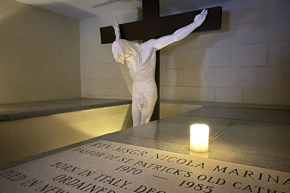 Things To Do in Little Italy with Kids: a Crucifix and candle at St. Patrick's Catacombs 
