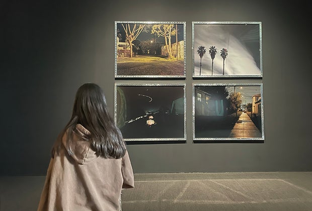 Visiting the Whitney Museum in NYC with Kids: Girl staring at a collection of paintings