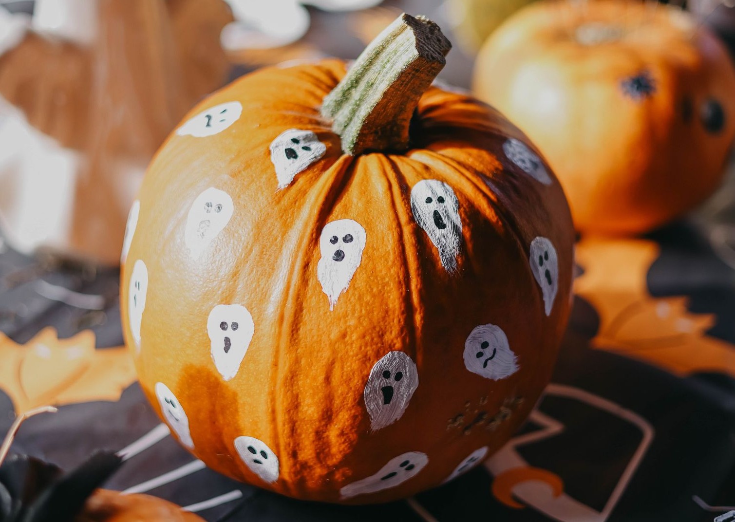 white thumbprint ghosts on a pumpkin make cute and easy decoration