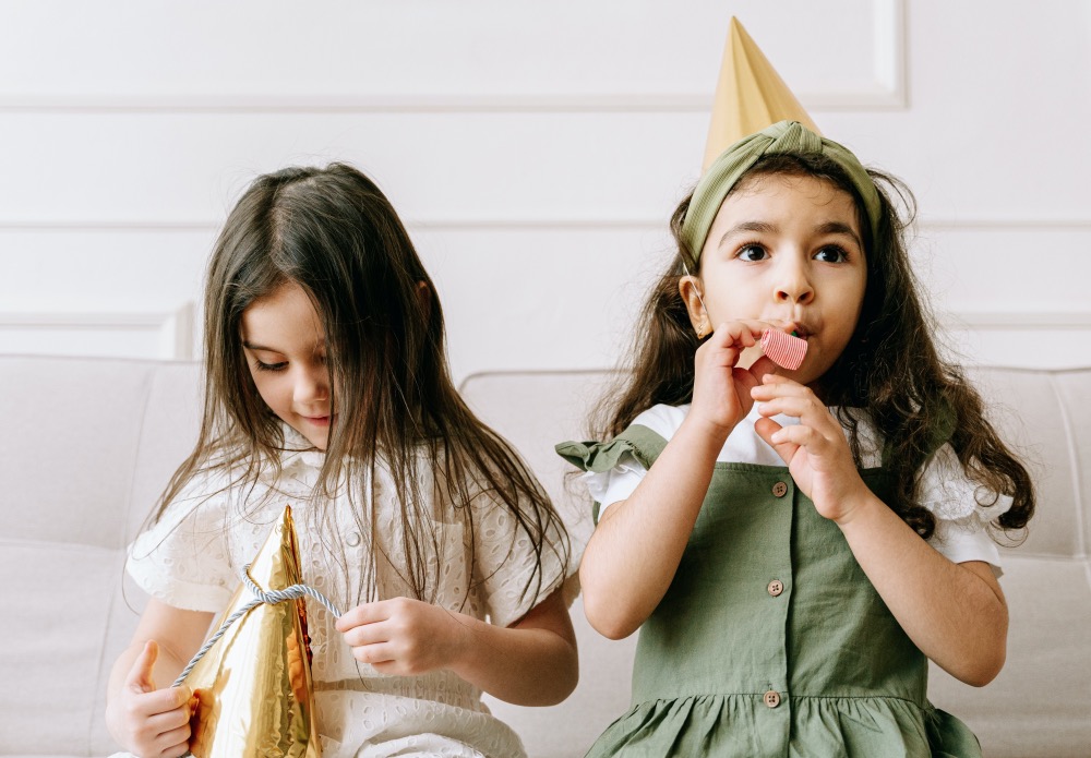 Noisemakers and party hats make the evening feel festive from the start! Photo by Ivan Samkov via Pexels