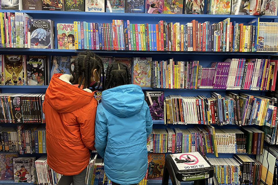 Atomic City Comics kids looking at books Black-Owned Restaurants, Retailers, and Landmarks to Discover in Philly