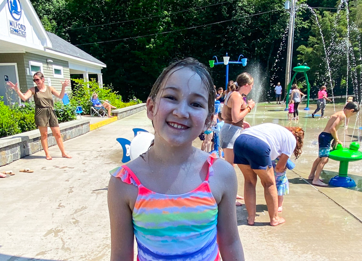Photo of child at splash pad in Bodie's Place in Milford, CT.
