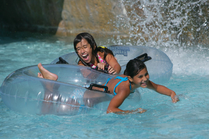 Photo of family swimming at Hurricane Harbor at Six Flags New England.