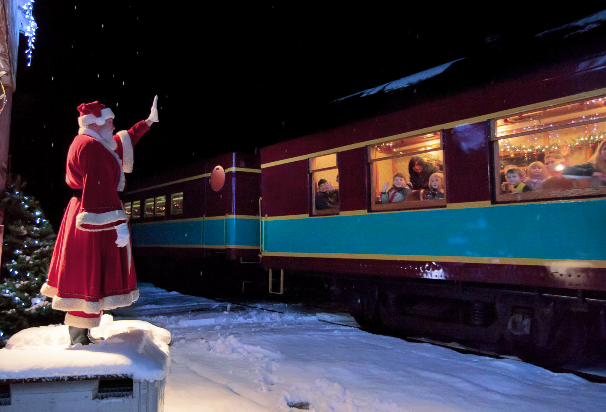 Santa waves to the Polar Express train from his post at the North Pole. Photo courtesy of Cape Cod Central Railroad