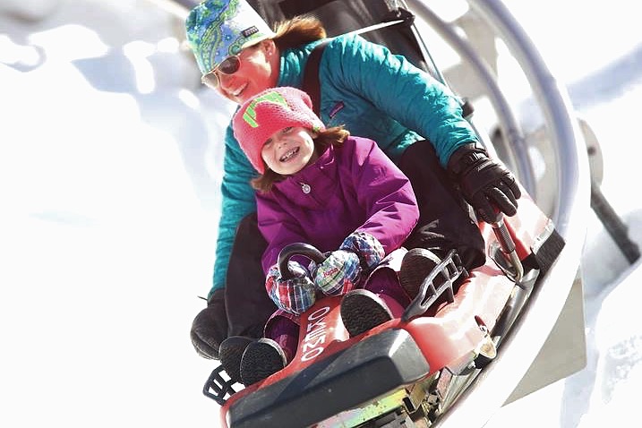 Image of parent and child on mountain coaster in New England