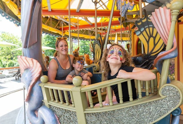 Photo of family on carousel on Boston Greenway.