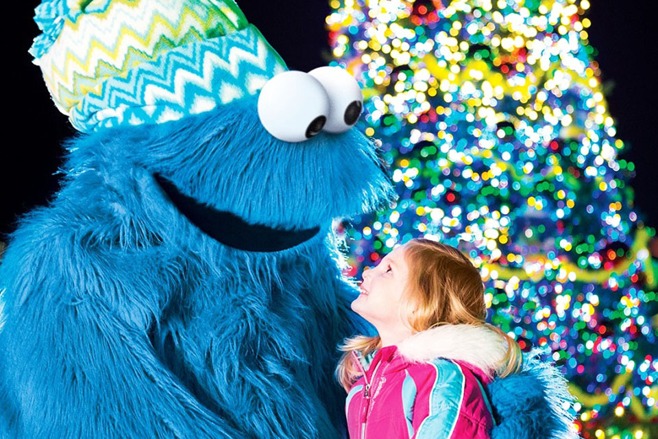Share a cookie with the Cookie Monster at a Very Furry Christmas at Sesame Place. Photo courtesy of Sesame Place