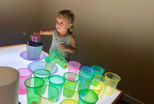 Little girl playing in the light lab at Imaginology Kids