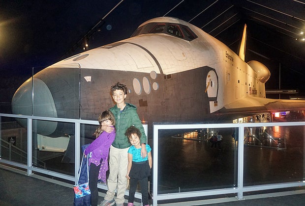 Three kids in front of the Space Shuttle Enterprise at the Intrepid, a space museum near NYC