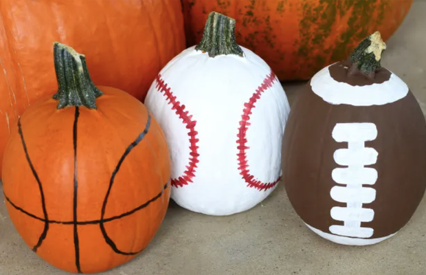 pumpkins painted to resemble basketballs baseballs and a football