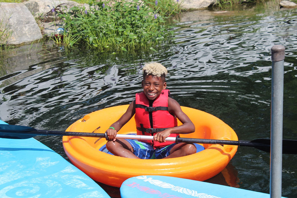  Spring Lake Day Camp has a 5-acre lake for boating, fishing, and water slides. Photo courtesy of the camp