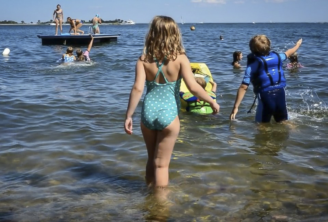 Image of children swimming at a beach and swim club in Connecticut.