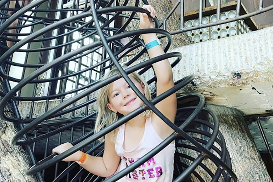 St. Louis with kids girl climbing play structure