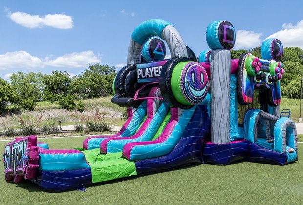 Orlando Fun Bounce's Glitch Gamer is a vibrant inflatable bounce house and slide combo, with gamer-inspired graphics and high-energy design. Photo courtesy Orlando Fun Bounce