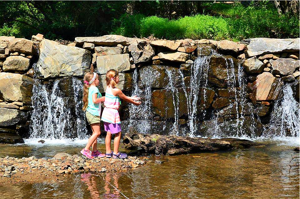 Delight in the calming waters of the mini-waterfall. 