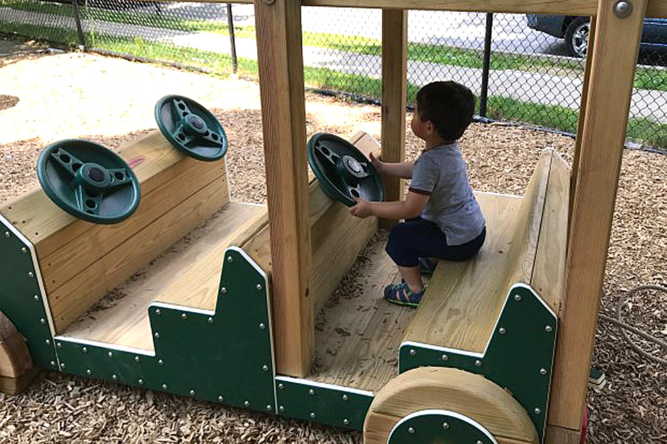 Little ones can take the wheel(s) of the wooden car at Sunset Park.