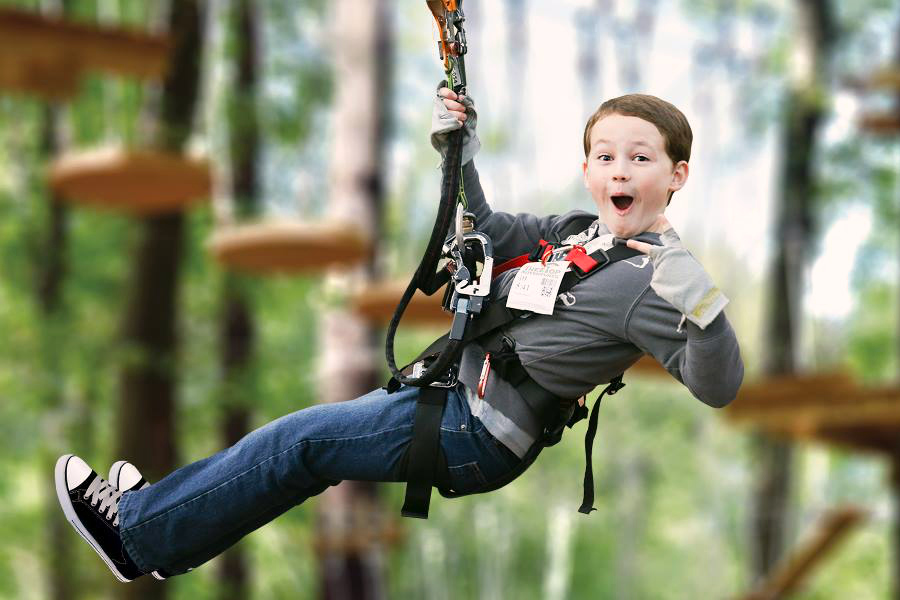 Photo of a child on a zip line, a popular Father's day activity.